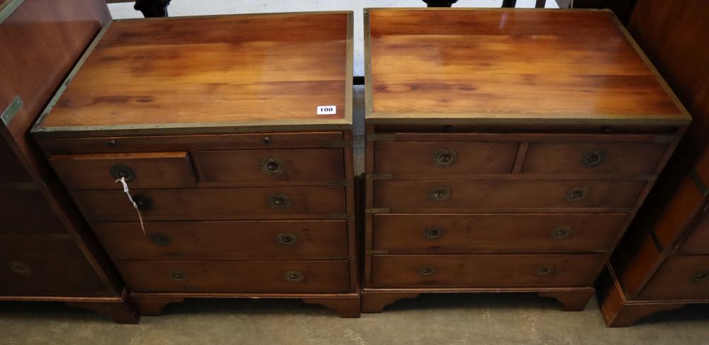 A pair of brass mounted yew wood campaign style chests, each with brushing slide, two short and three graduated long drawers, width 56c